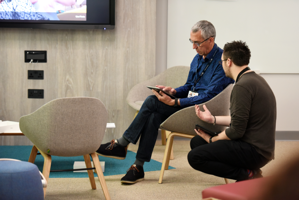 A member of the Digital Learning Team talks to an academic member of staff about their use of technology