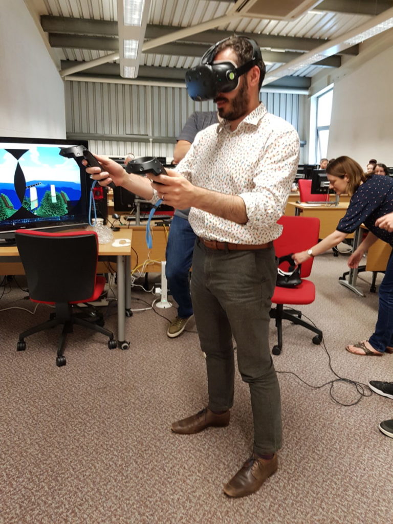 Prof Tim Thompson (Associate Dean Learning & Teaching, SSED) testing the VR goggles to navigate Minecraft world.