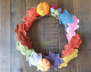 Photo of autumn wreath with knitted leaves attached. 