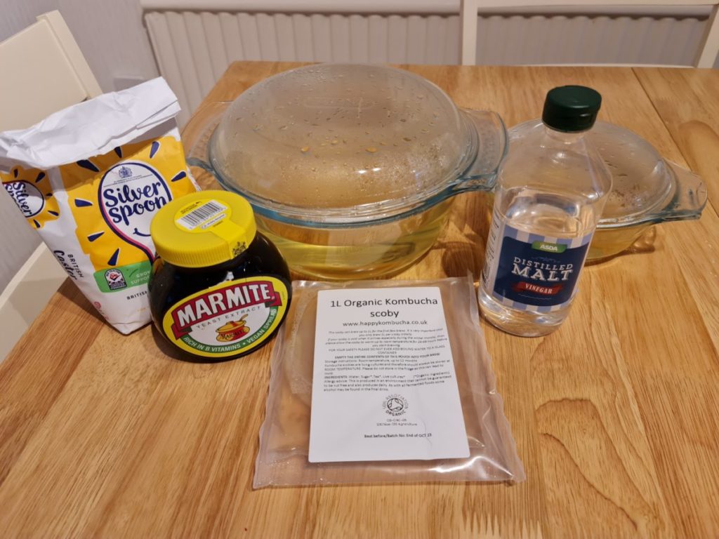 Photo showing the ingredients of the fermentation broth: sugar, marmite, vinegar and Scoby. 