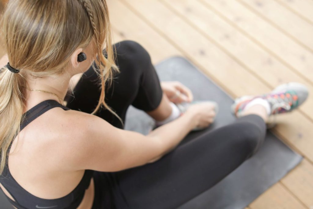 Image of person sitting on a gym mat.