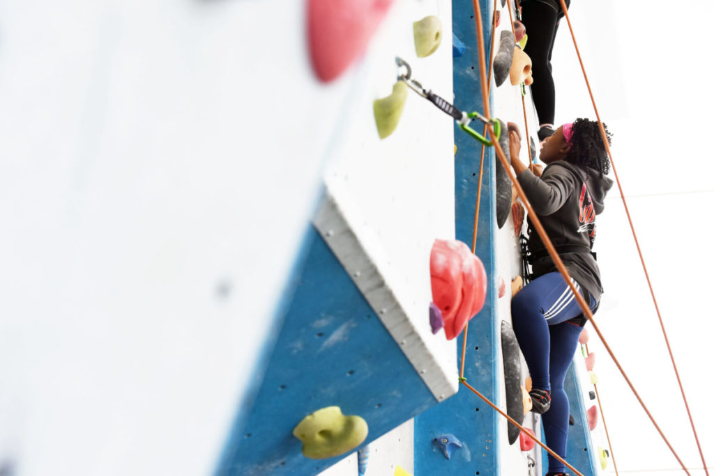 Somebody scaling the climbing wall