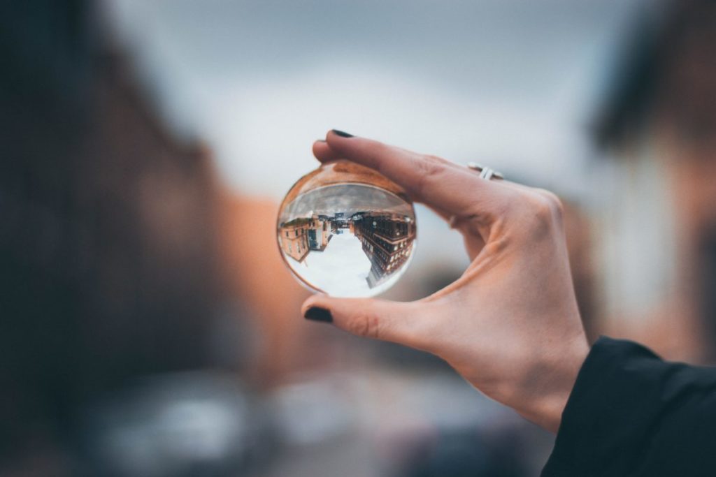 Image of a hand holding a glass orb.