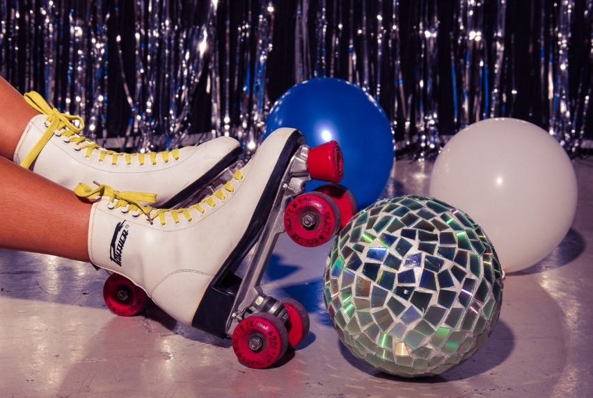 Roller skates, disco ball and balloons