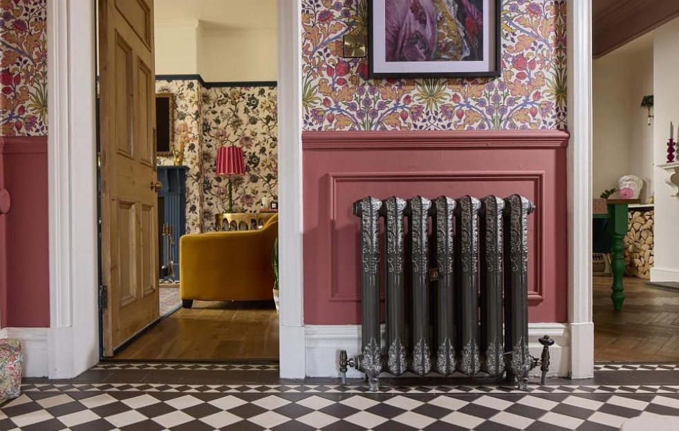 Image of the panelled hallway at Casa Oldcorn. Terracotta panelling and floral patterned wallpaper above. 