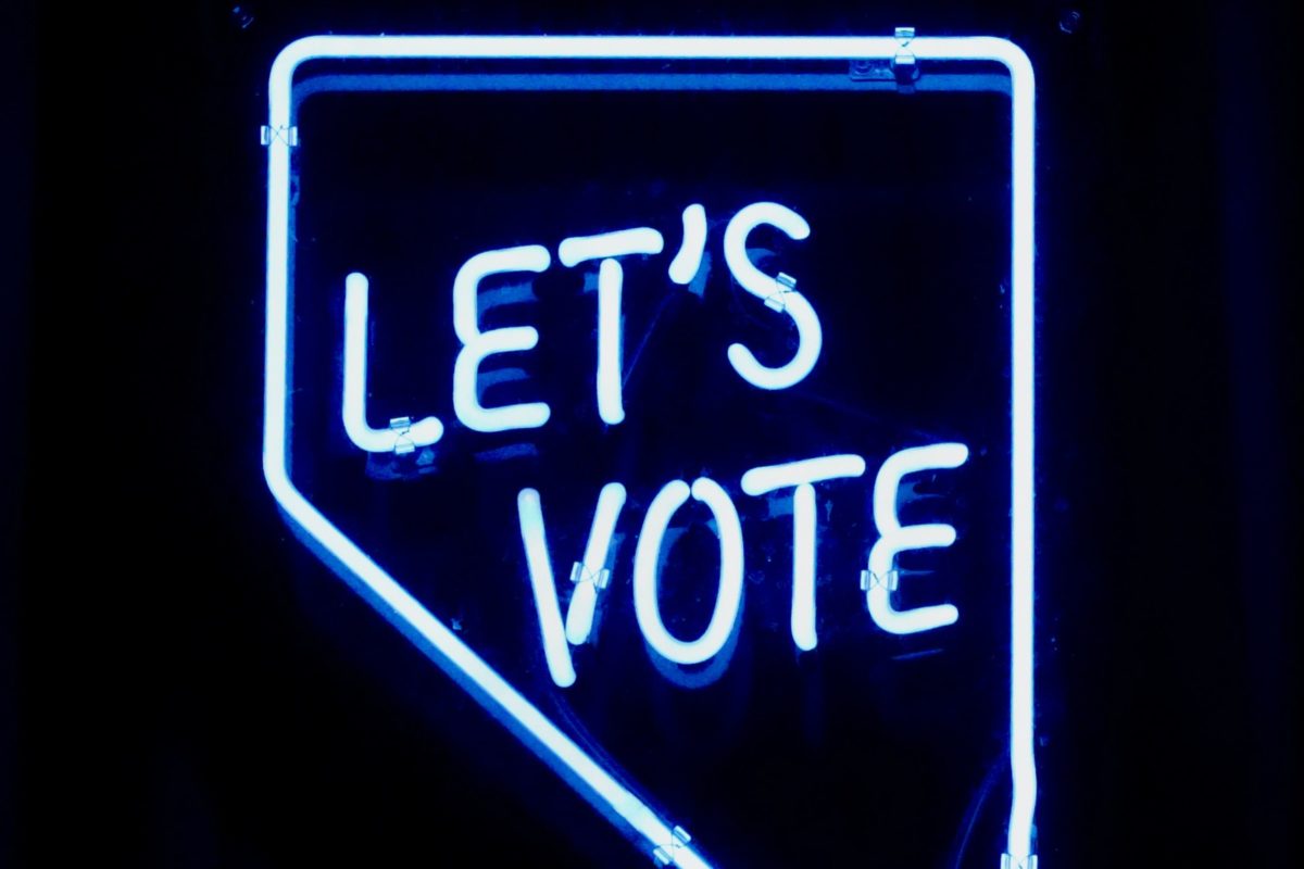 Neon sign saying 'Let's Vote'