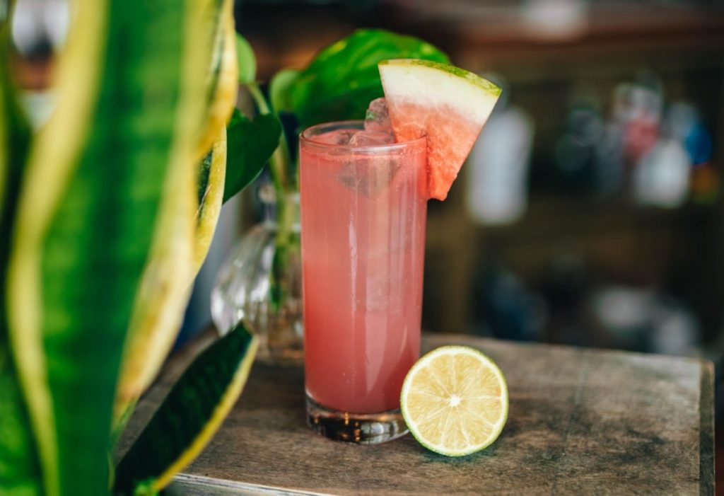 Watermelon mojito placed in a bar setting.