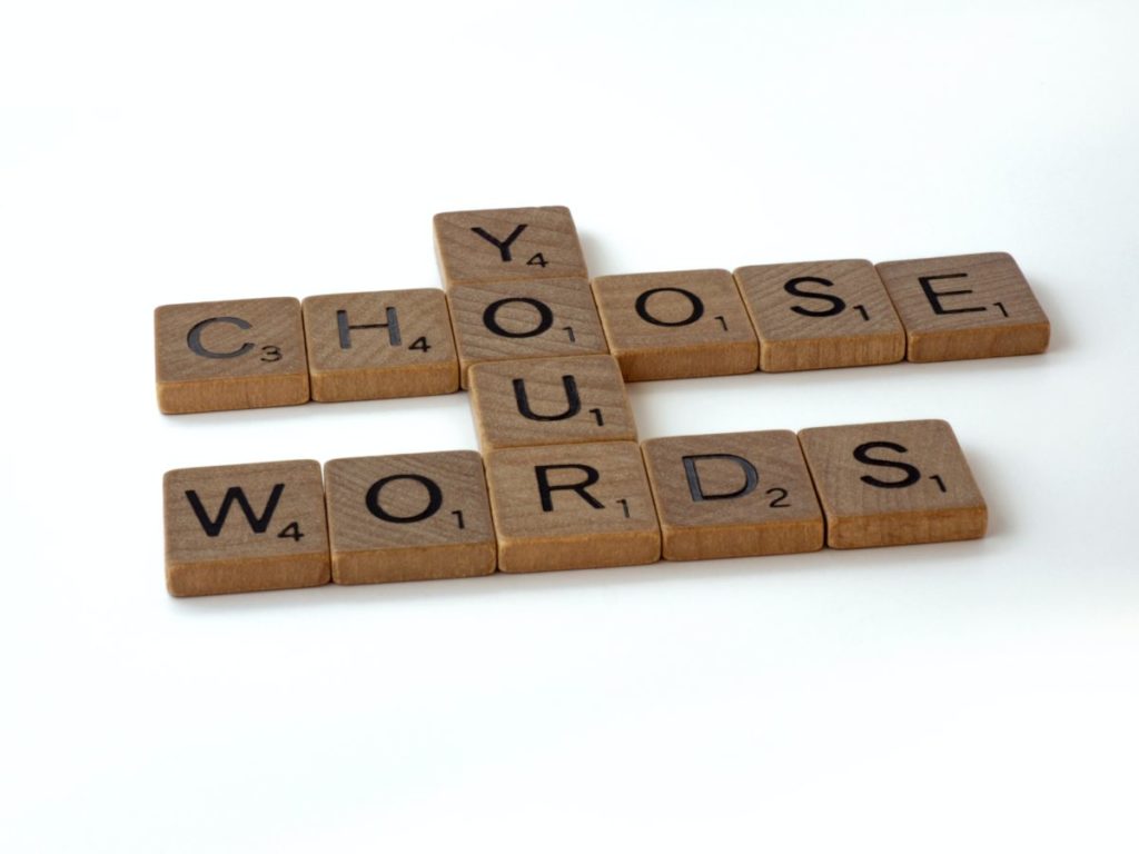 Scrabble letters spell out "Choose your words"