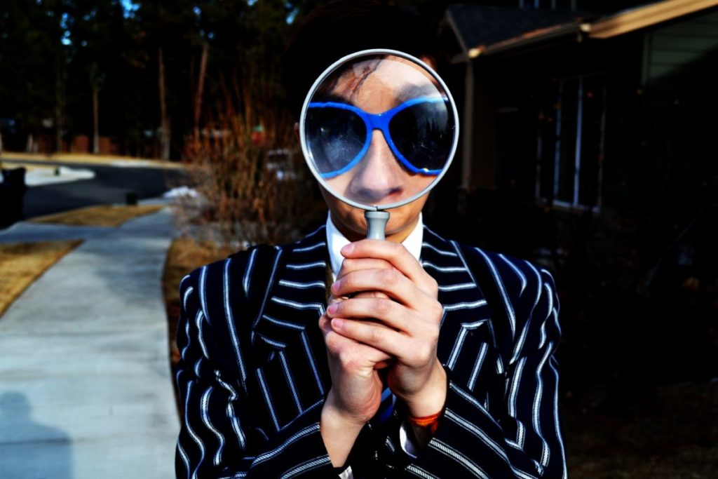 Person holding a magnifying glass up