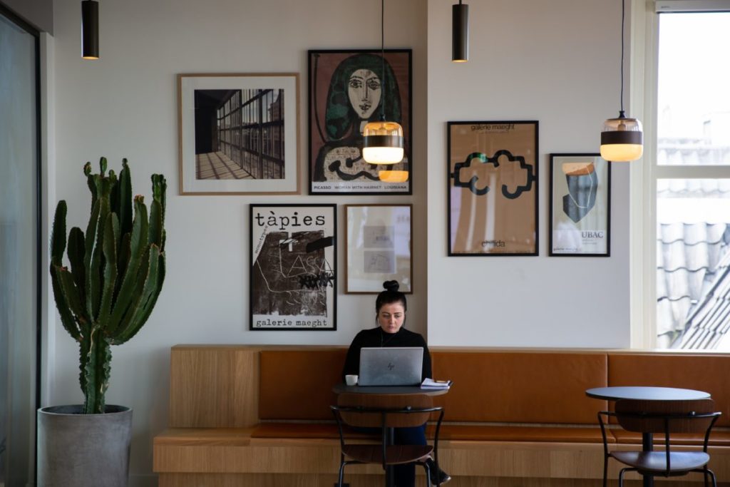 A young woman sitting at a table using a laptop