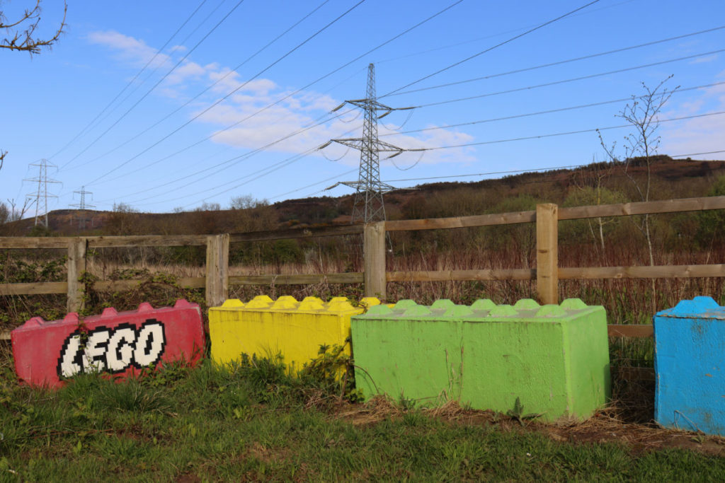 Large concrete blocks painted to look like colourful LEGO bricks