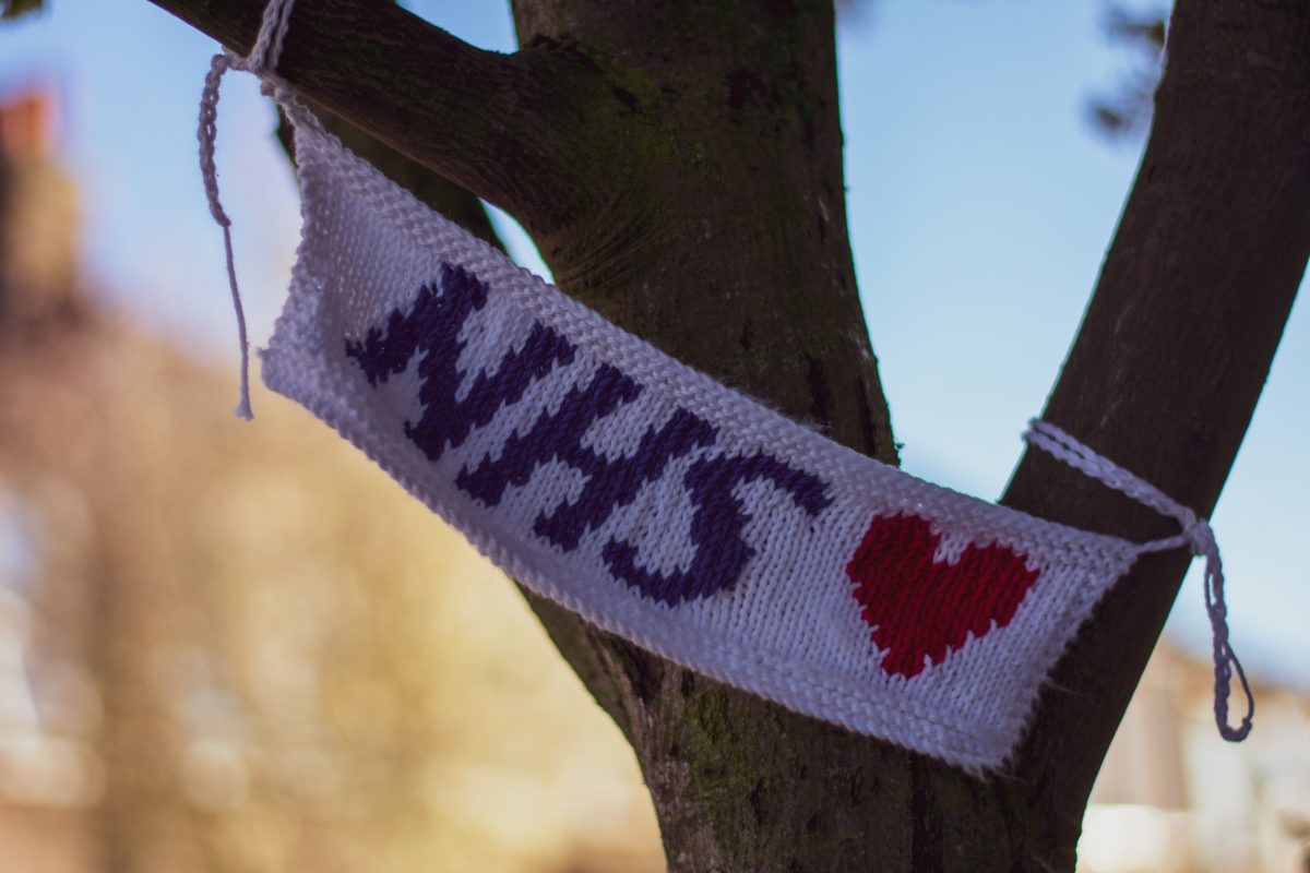 NHS knitted banner hung in a tree