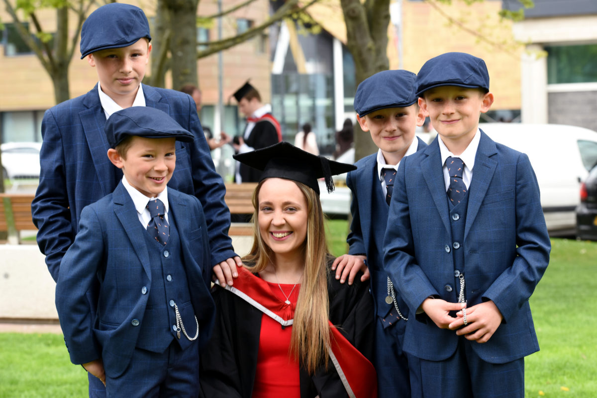 A mum with her four sons, all wearing matching suits