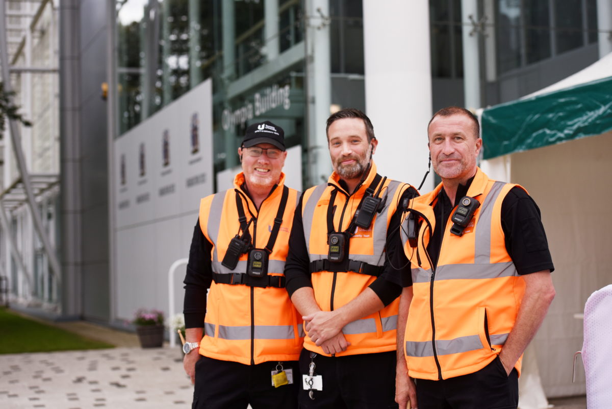 Members of the Teesside University security team smiling on campus