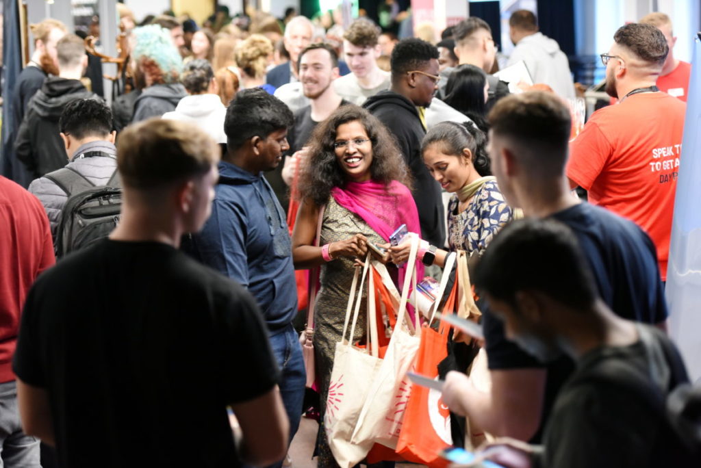 A large group of students in the societies fair hall