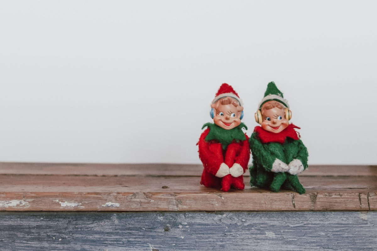 Two elves sat together listening to music through large headphones