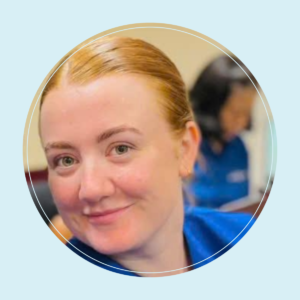 Katelyn has ginger hair and wears a nursing uniform