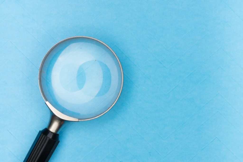 Magnifying glass resting on a blue table