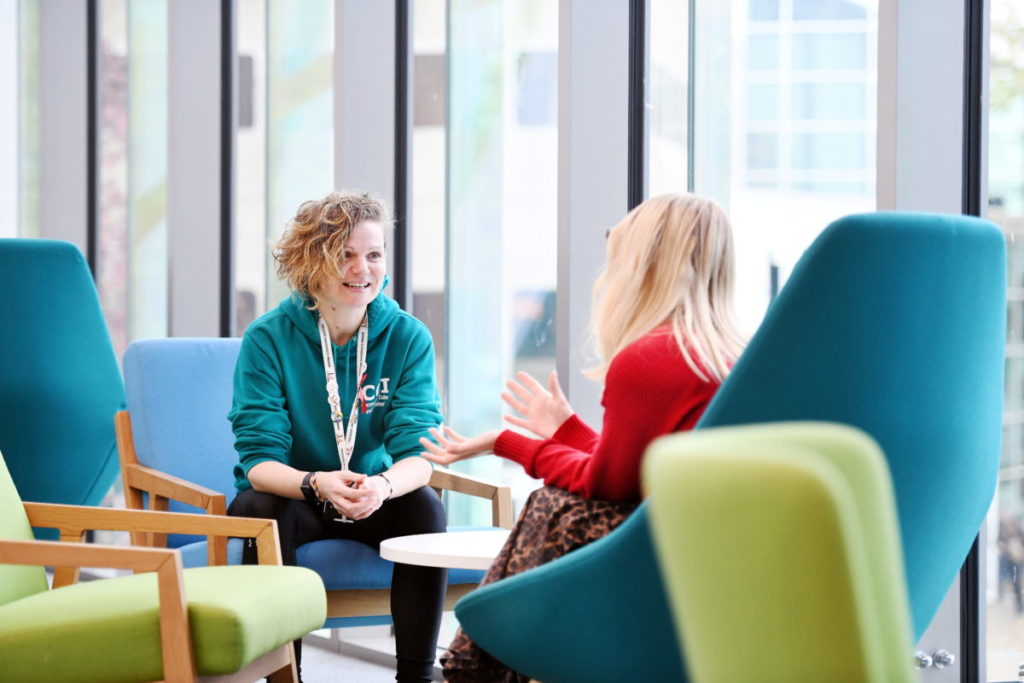 Student talking to an adviser on campus
