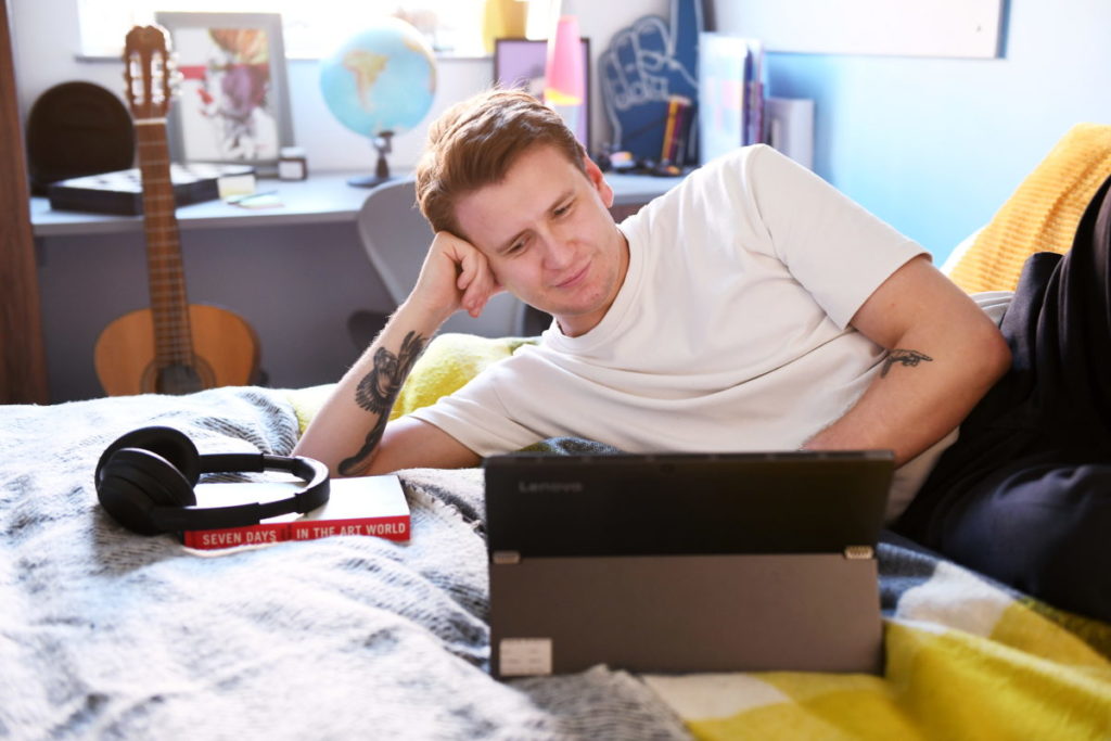 Student on his laptop in his room